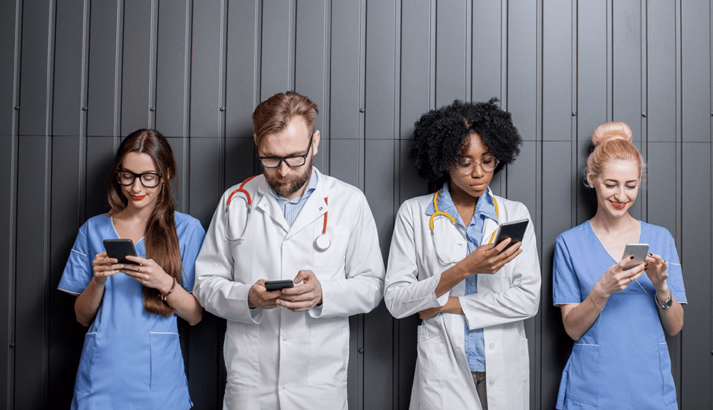 Group of diverse healthcare professionals using smartphones