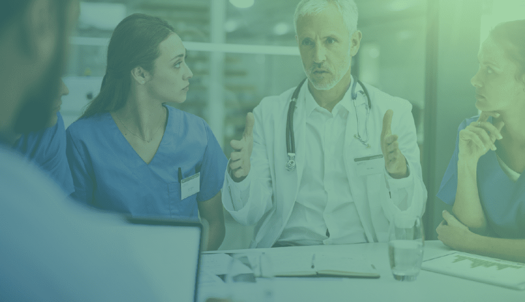 Senior doctor discussing with colleagues at a conference table