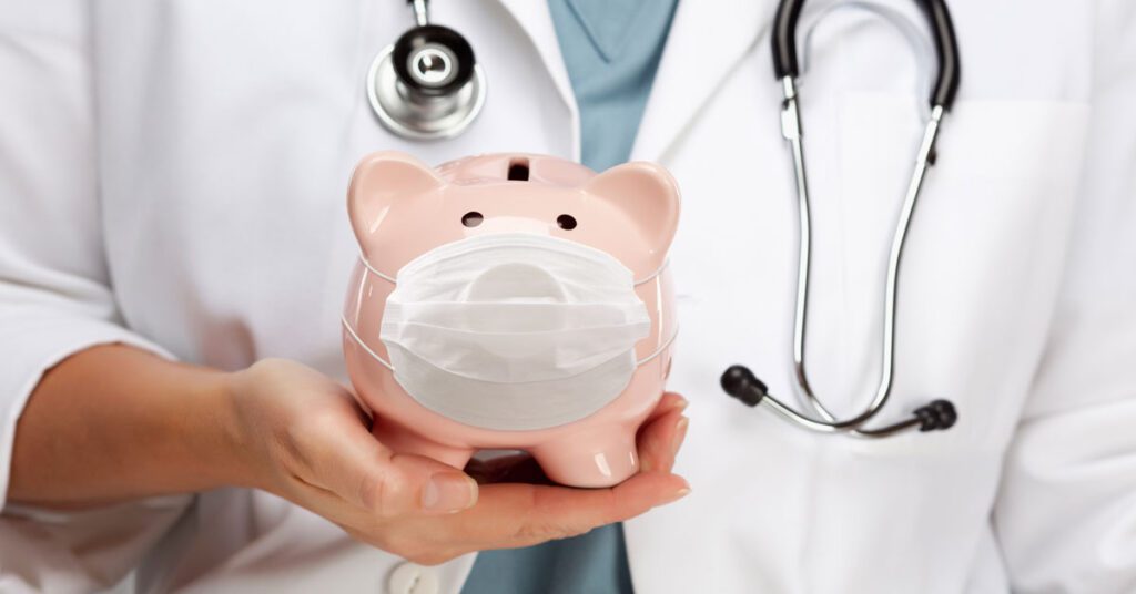 Doctor holding a piggy bank wearing a face mask