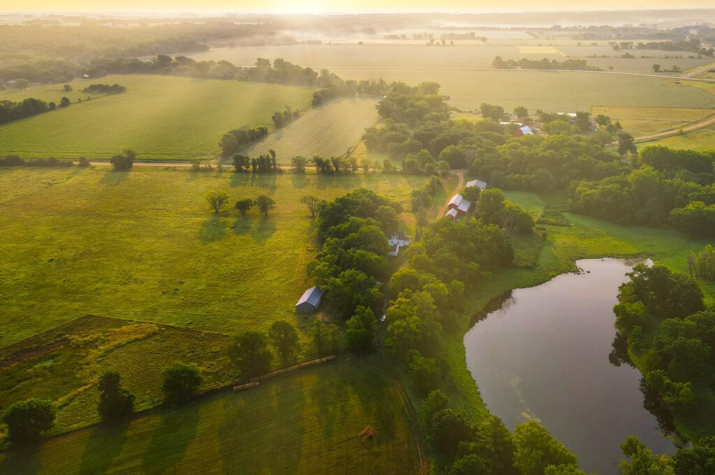 aerial view of farmland with a pond