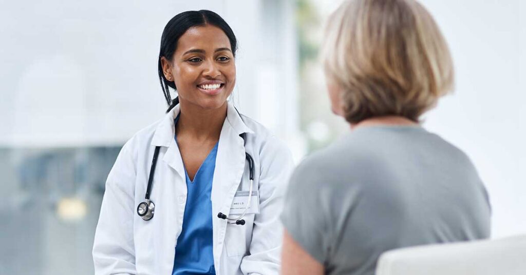 Female doctor smiling while consulting with a patient