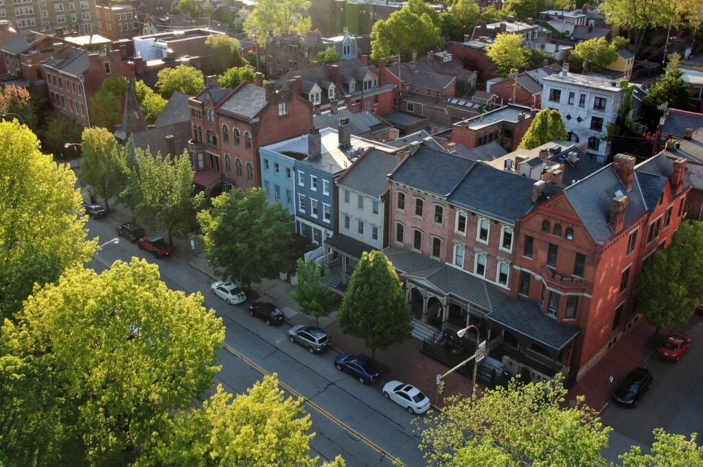 Aerial view of a street with historic brick townhouses in a residential neighborhood