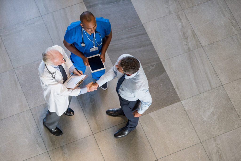 Healthcare professionals discussing strategies in a post-pandemic market, highlighting physician recruitment trends.