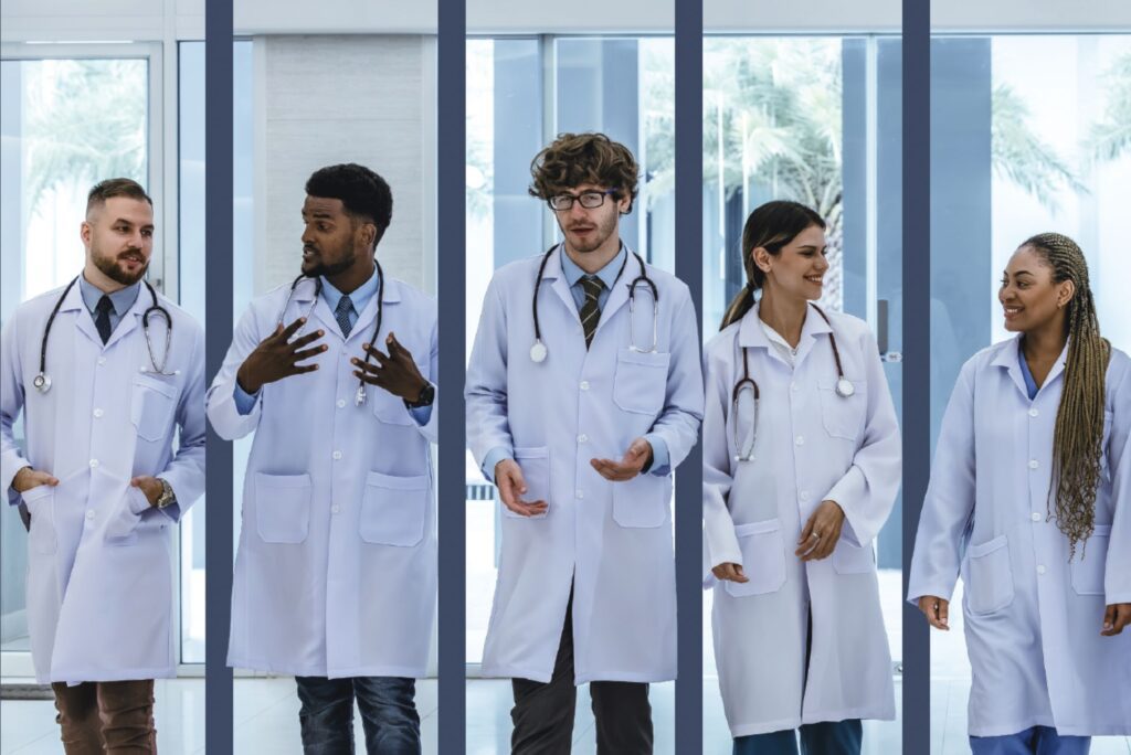 Group of medical professionals in lab coats walking and discussing in a hospital