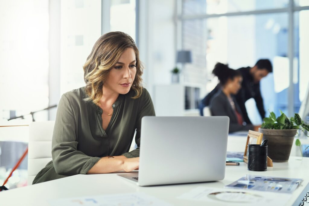 Woman working on a laptop at a desk