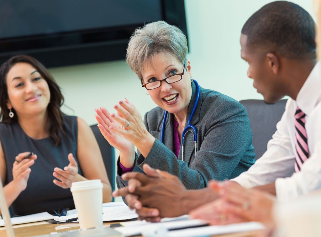 three physicians at a conference in a meeting