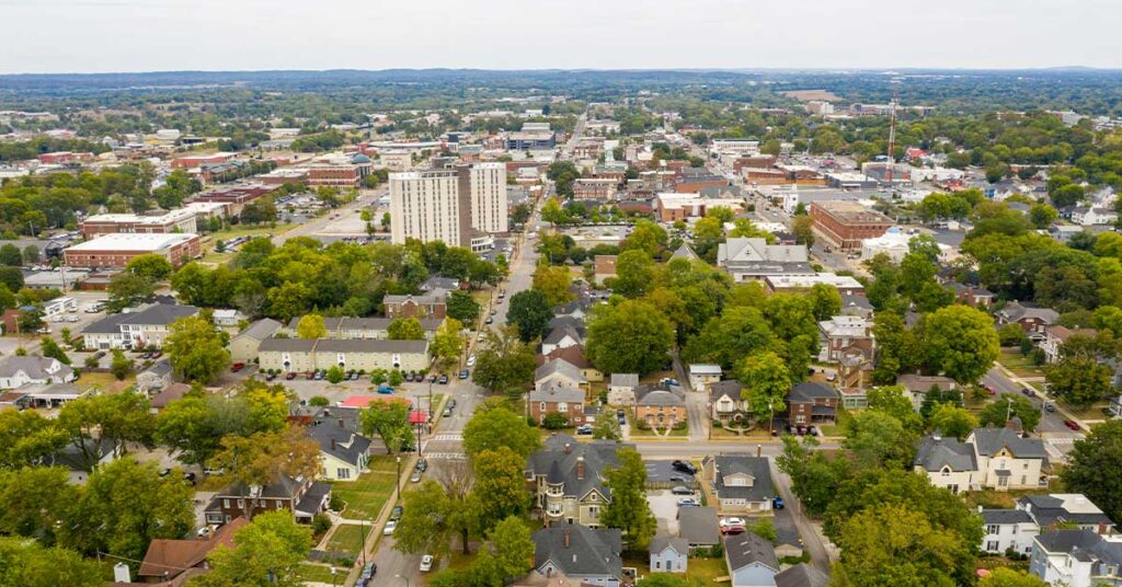 Aerial view of a suburban town with trees and residential buildings