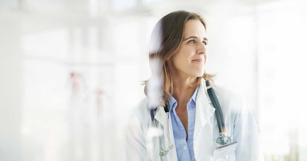 female physician smiling and looking into distance