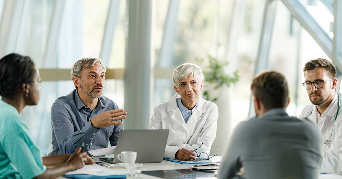 Group of doctors and recruiters talking in a meeting